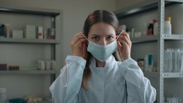 Pharmacist Woman Putting on Medical Mask at Drugstore