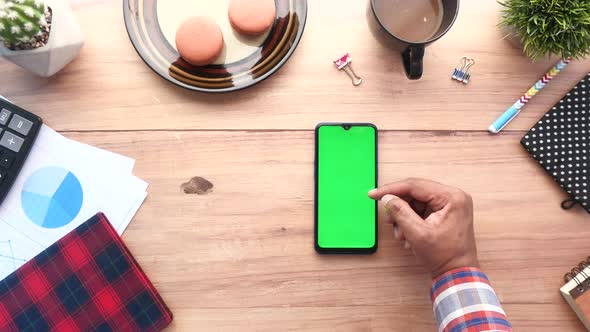 Top View of Man Hand Using Smart Phone on Office Desk