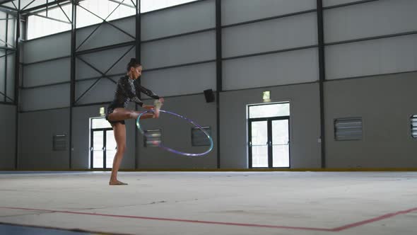 Female gymnast performing at sports hall