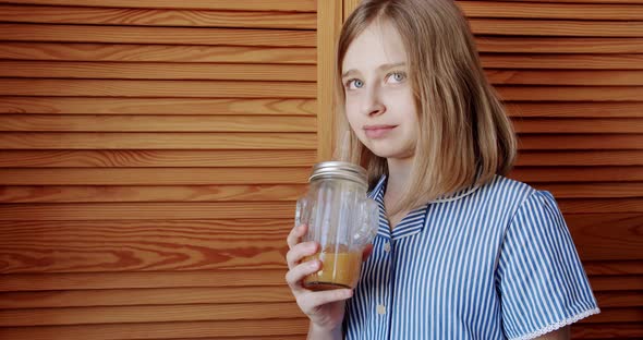 Cute Teenage Girl Drinking Fresh Orange Juice From Glass at Home Tasty Drink