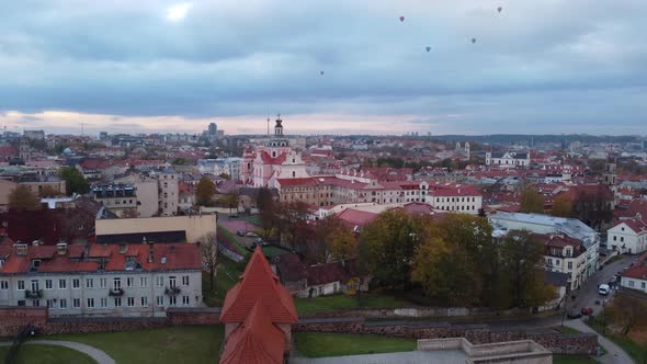View From The Bastion Of Hot Air Balloons In Flight Over Old Town Of Vilnius In Lithuania With Churc