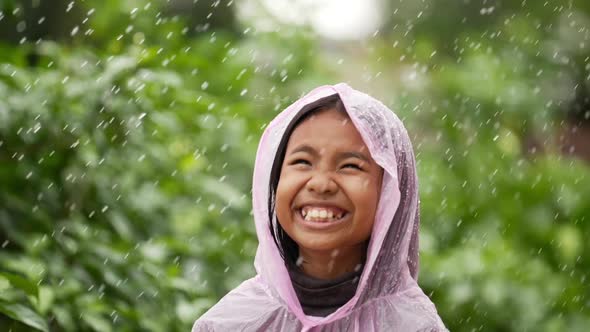 Happy girl wears raincoat