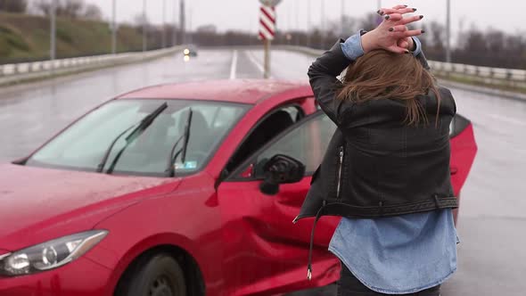 A Woman Was in an Accident on the Road in the Rain, She Is Injured and Scared