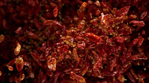 Super Slow Motion Shot of Dried Red Chili Peppers Explosion on Black Background at 1000Fps