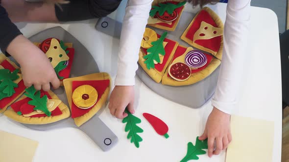 Children play with toy pizza. Felt pizza. Felt food toys for the kids