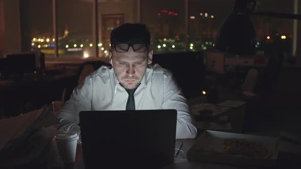 Businessman Working on Laptop at Night