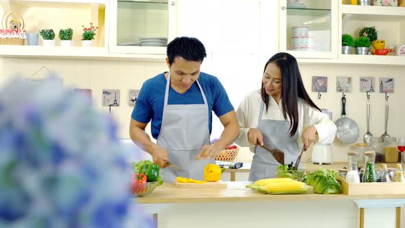 Young Asian Couple Enjoy to Preparing Food in the Kitchen