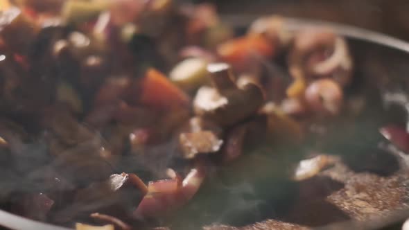 Vegetables Flying Into the Pan in Slow Motion. Onions, Broccoli, Mushrooms, Champignons, Tomatoes