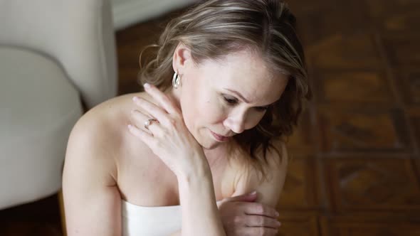 Portrait of a Beautiful Middleaged Woman with Blonde Hair and Open Shoulders