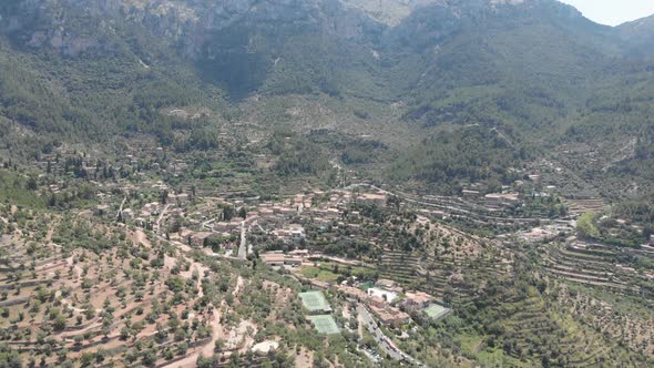 Aerial view, birds eye of Valdemossa city with mountains of Tramuntana in the background in Mallorca