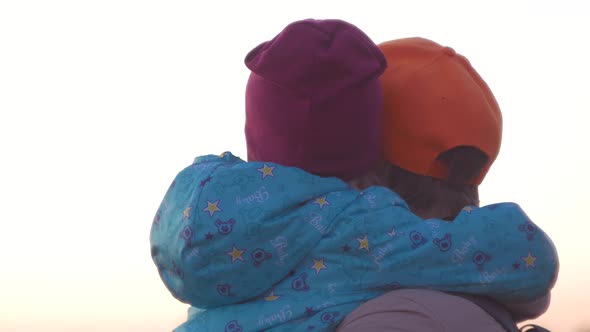 Father and daughter standing on cold autumn evening city lanscape. A little girl hugging and kissing