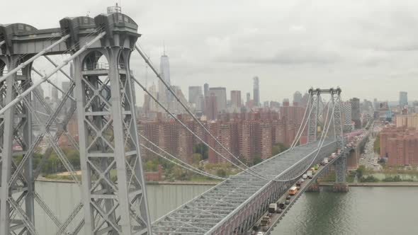 AERIAL: Flight Over Williamsburg Bridge Manhattan Side with New York City Skyline at Cloudy Day 