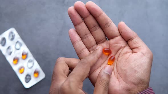 Top View of Vitamin Capsule on Person Hand 