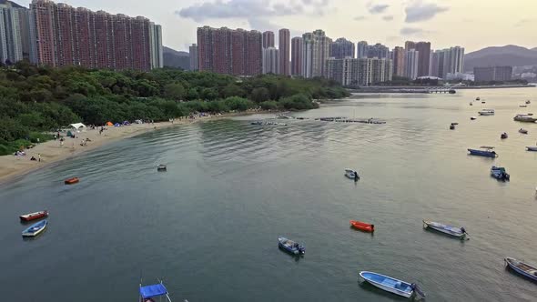 A dynamic aerial footage of various boats near the beach of Sai Kung town in Hong Kong. The Sai Kung