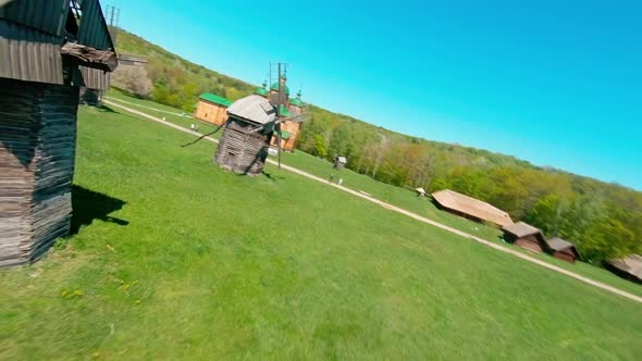 FPV Drone Flies Over the Ukrainian Authentic Village of Pirogovo with Windmills Near Kiev