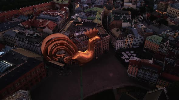 Aerial Top View Golden Weather Cock in Riga Old Town During Amazing Scenic Sunrise Aerial