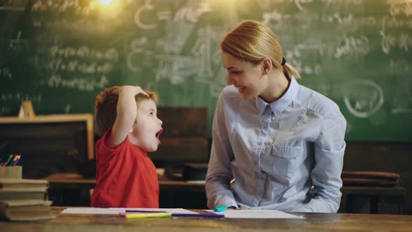 Mother an Kid Son in Elementary School. Preschool Kids. Teacher and Child Having Fun on Learning in