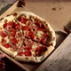 Delivery pizza box. Chopped hot pizza in a cardboard box. Pizza with meat and cheese. - VideoHive Item for Sale