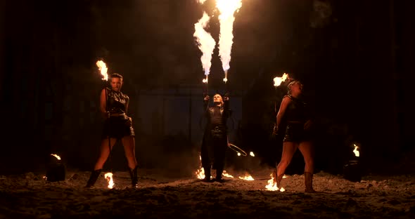 Slow Motion Professional Fire Performance Three Women with Torches and a Man with Flamethrowers