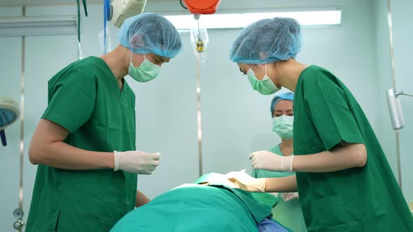 Professional surgeons team performing surgery in the operating room, surgeon, Assistants, and Nurses