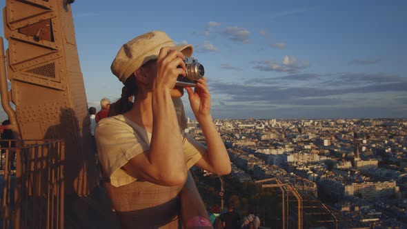 Young girl taking photo of the city