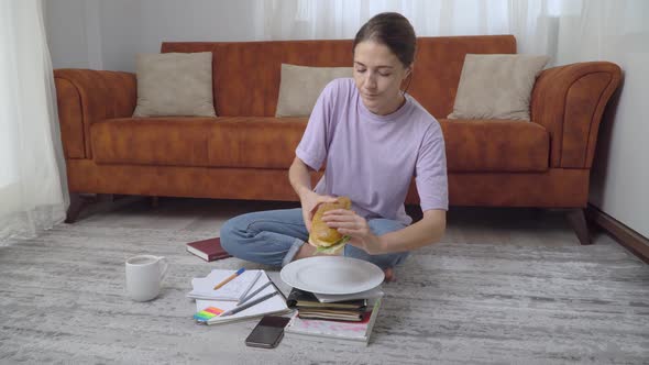 Snack During School the Girl Eats a Sandwich and Drinks Coffee with Textbooks and Notebooks Home