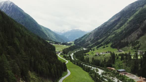 Panoramic View of a Picturesque Mountain Valley with a Village in a Lowland