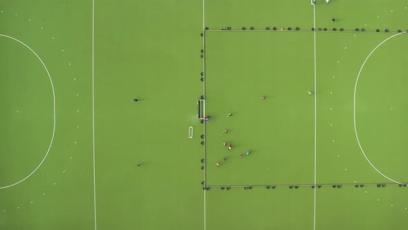Field hockey playing process from aerial top view.