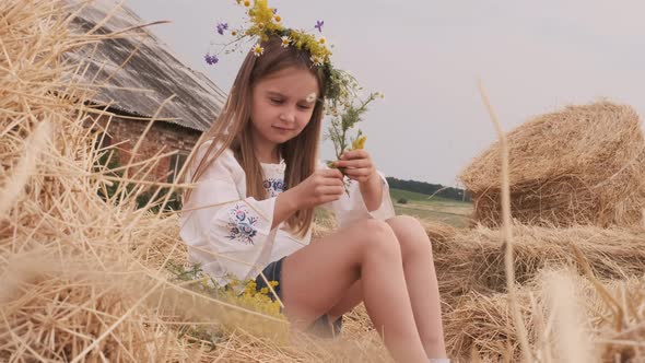 Girl Sitting on Hay