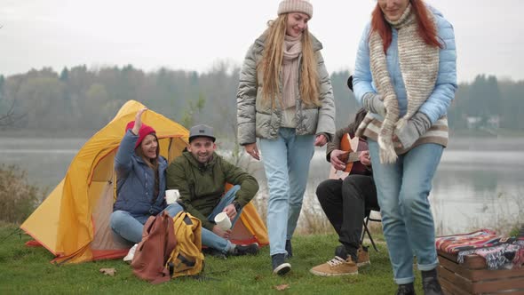 Adventure, Travel, Tourism and People Concept - Group of Smiling Friends with Marshmallow