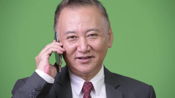 Mature Japanese Businessman Using Phone