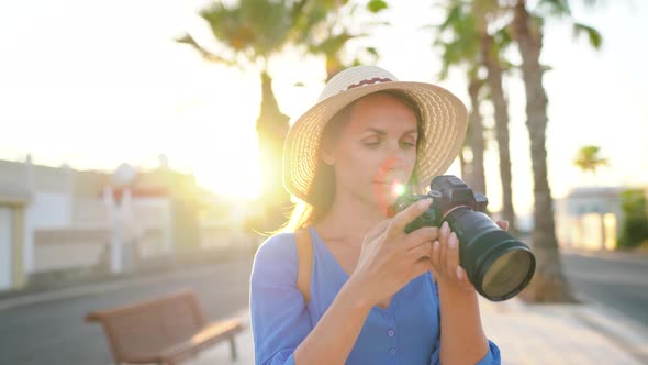 Photographer Tourist Woman Taking Photos with Camera in a Beautiful Tropical Landscape at Sunset