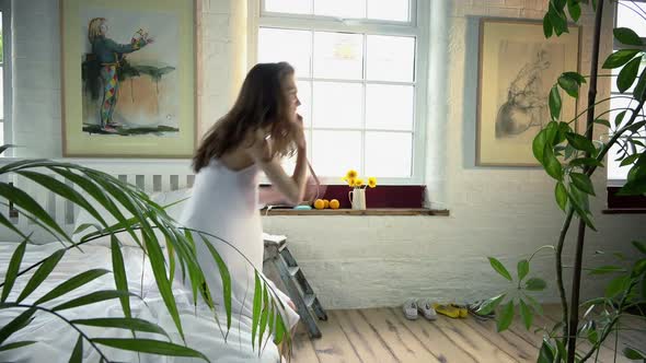 Woman with phone sitting down on bed