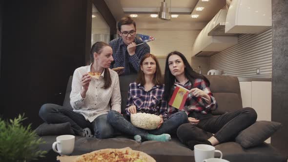 Four People Sitting on Couch, Watching Tv