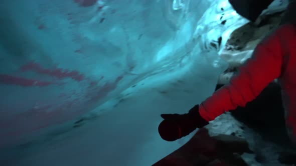 A Girl Touches Centuriesold Ice in an Ice Cave