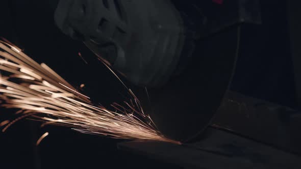 Man Works With Electric Grinder.