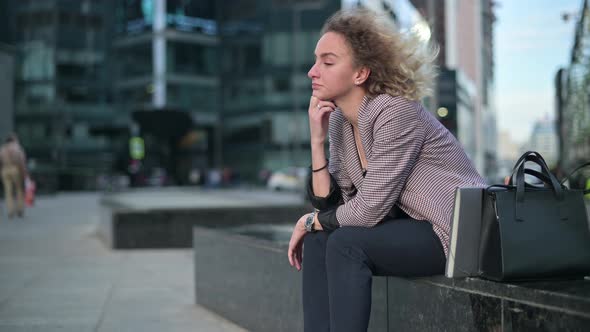 office worker, woman, sitting upset after work. She was laid off from her job