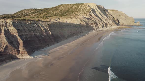 Long sand strip , idyllic and quiet Praia da Luz, Algarve. Ocean and beach vacations. Aerial forward