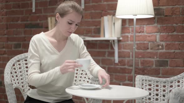 Young Woman Having Headache and Drinking Coffee