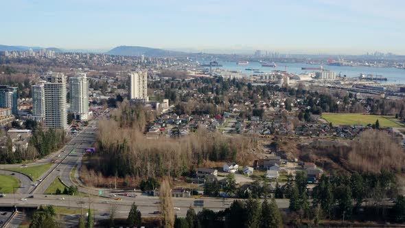 Modern Downtown Structures And Hustling Cars On The Highway Of Lions Gate Bridge In Vancouver, Canad