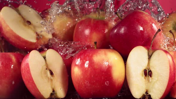 Slow Motion Shot of Red Apple Water Splashing Through Apple Slices