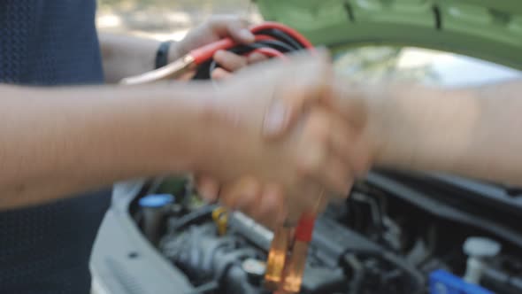 A Man Shakes Hands with a Motorist Thanking Him for His Help on the Road