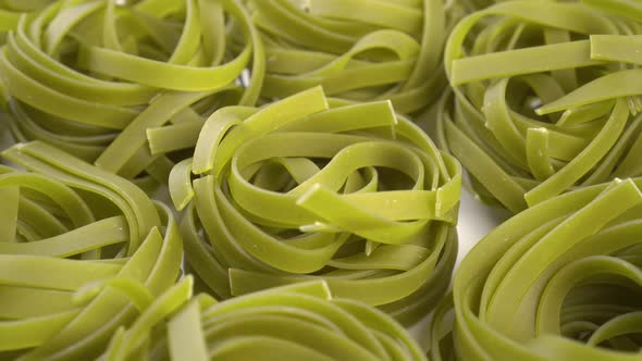 Dry green nest pasta tagliatelle close up