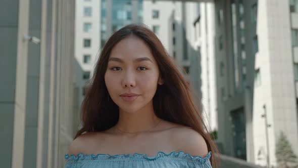 Close Up Portrait Asian Young Woman in with Bare Shoulders Outfit Looking to Camera Outside on