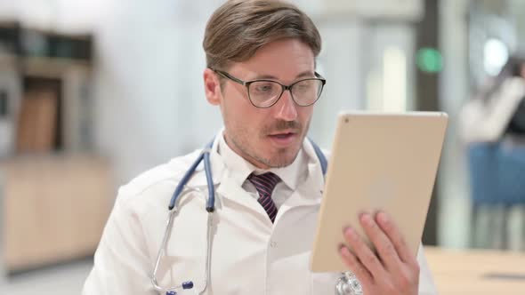 Portrait of Male Doctor Talking on Online Video Chat on Tablet