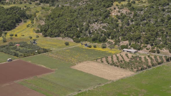 Aerial View of Helicopters Flying Over Farm Land and Fields in Greece