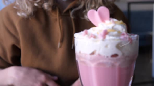 Woman Drinking Glass Of Pink Latte With Beetroot Juice, Plant Milk. Healthy Vegan Drink.