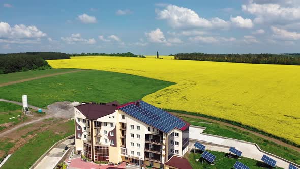 Modern buildings in village. Aerial shot of home with solar system in residential area in countrysid