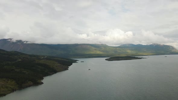 Beautiful View of Lake Alongside Scenic Road Surrounded By Mountains