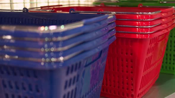 Closeup Colored Plastic Baskets in the Supermarket